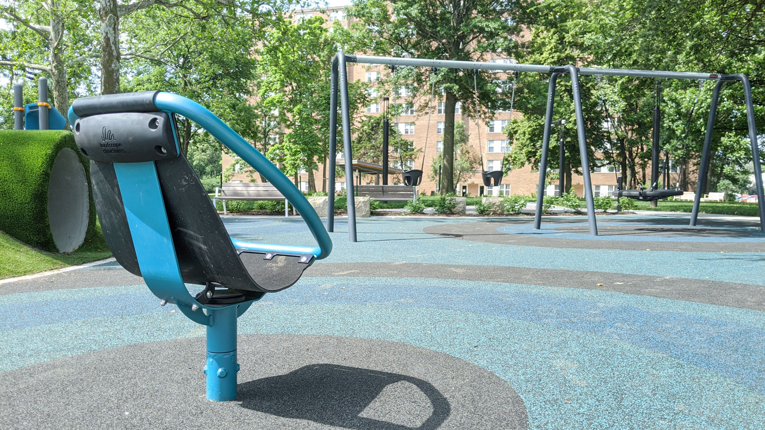 This is an image of downtown overland park thompson park playground spinner swing web