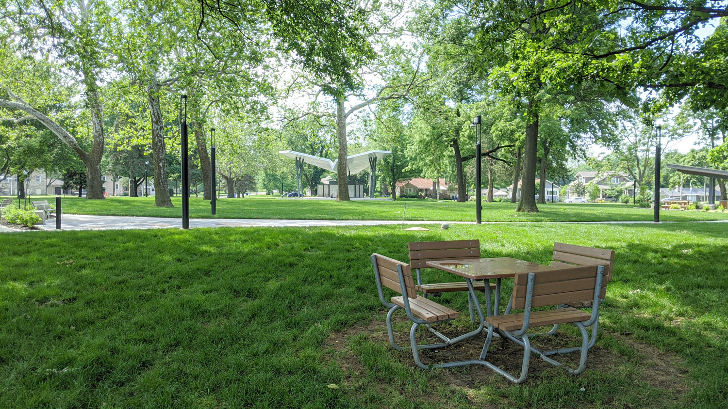 This is an image of downtown overland park thompson park green space table paper airplane lawn web