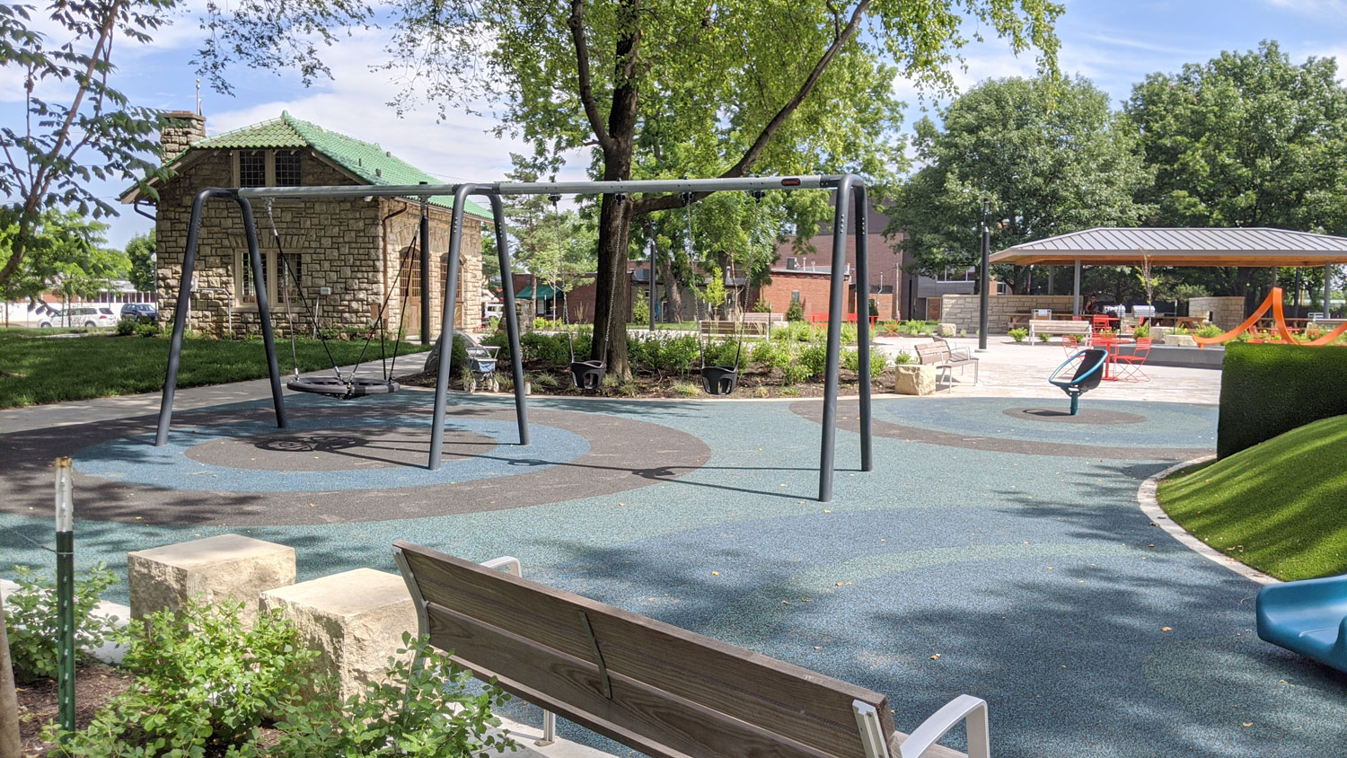 This is an image of downtown overland park thompson park playground swings carriage house web