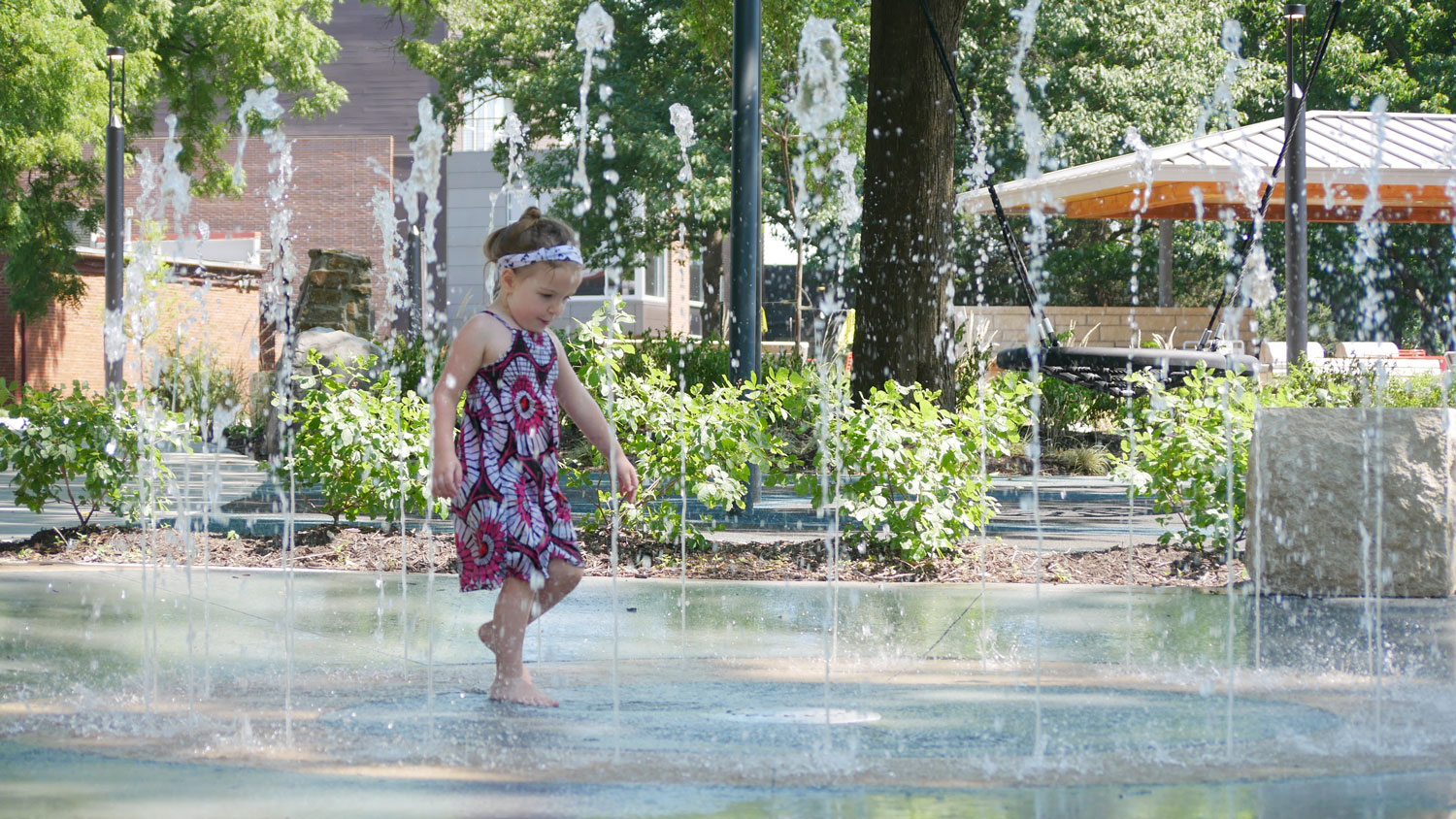 This is an image of downtown overland park thompson splash pad girl cu web